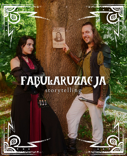 Two people in fantasy costumes pose by a tree in a forest, promoting a storytelling show called FABULARUZAGA.