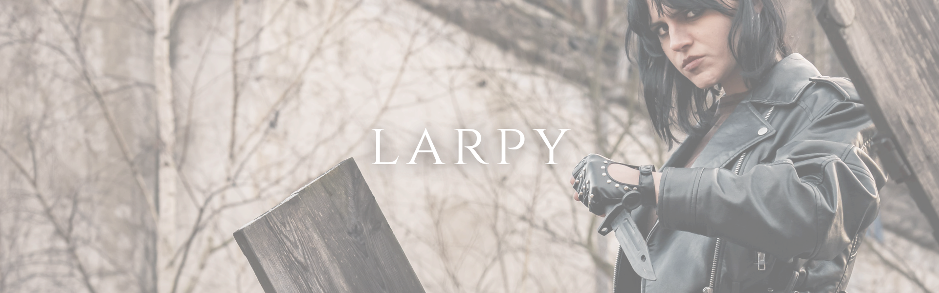 Person in a black leather jacket outdoors, gripping a knife, with the word LARPY across the center.